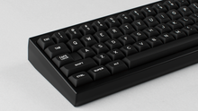 Load image into Gallery viewer, MTNU WoB on a black and gold keycult No. 2 zoomed in onleft side