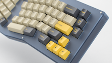 Load image into Gallery viewer, Render of DCS Mudbeam keycaps on a navy Kolibri ergo keyboard, close-up