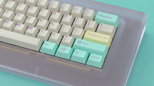 Load image into Gallery viewer, render of GMK CYL Analog Dreams R3 keycaps, close-up on a Piggy keyboard with mint accents and a yellow Analog Dreams shift key