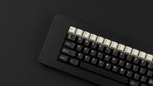 Load image into Gallery viewer, GMK CYL Black Snail on a black keyboard zoomed in on left