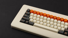 Load image into Gallery viewer, GMK CYL Carbon R3 on a cream colored keyboard close up on left side angled