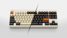 Load image into Gallery viewer, GMK CYL Carbon R3 on a cream colored keyboard preview of both base kits
