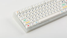 Load image into Gallery viewer, GMK CYL Dots light base on a clear keyboard zoomed in on left