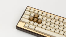 Load image into Gallery viewer, GMK CYL Rainbow 6 Siege - Winner's Circle on a Dark Gold Keycult Zero with Gold HHKB accent bars close up on left side angled