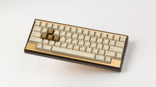 Load image into Gallery viewer, GMK CYL Rainbow 6 Siege - Winner's Circle on a Dark Gold Keycult Zero with Gold HHKB accent bars angled