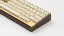 Load image into Gallery viewer, GMK CYL Rainbow 6 Siege - Winner's Circle on a Dark Gold Keycult Zero with Gold HHKB accent bars close up on right side angled