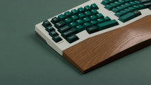 Load image into Gallery viewer, GMK CYL Taiga R2 keycaps on white ergonomic Alice keyboard with walnut wrist rest, close-up of left side on green background