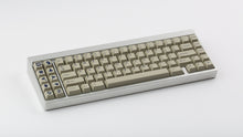 Load image into Gallery viewer, GMK CYL Winkler on a silver keyboard angled