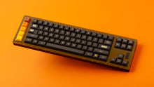 Load image into Gallery viewer, GMK MTNU 800 on a translucent orange and black keyboard angled