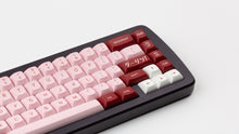Load image into Gallery viewer, GMK MTNU Darling on a purple keyboard close up on right side