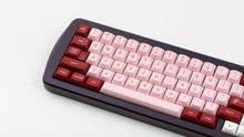 Load image into Gallery viewer, GMK MTNU Darling on a purple keyboard close up on left side
