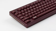 Load image into Gallery viewer, GMK MTNU Rascals on a burgundy Keycult No. 1 TKL keyboard close up on left side angled