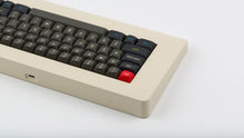 Load image into Gallery viewer, MTNU Susu on a beige keyboard back view left side