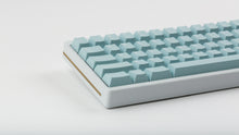 Load image into Gallery viewer, Key kobo Glacier on a white keyboard zoomed in on left