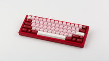 Load image into Gallery viewer, Key Kobo Darling on a red keyboard angled