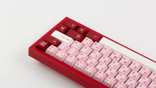 Load image into Gallery viewer, Key Kobo Darling on a red keyboard zoomed in right