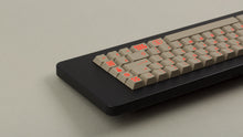 Load image into Gallery viewer, Key Kobo Signet on a black keyboard back right angle