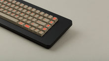 Load image into Gallery viewer, Key Kobo Signet on a black keyboard zoomed in on right