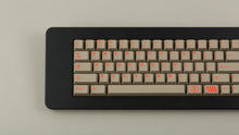 Load image into Gallery viewer, Key Kobo Signet on a black keyboard zoomed in on left