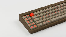 Load image into Gallery viewer, Key Kobo Signet on a brown keyboard zoomed in on left