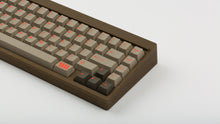 Load image into Gallery viewer, Key Kobo Signet on a brown keyboard zoomed in on right