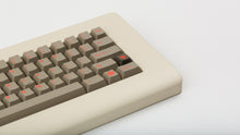 Load image into Gallery viewer, Key Kobo Signet on a beige keyboard zoomed in on right