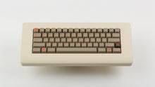 Load image into Gallery viewer, Key Kobo Signet on a beige keyboard