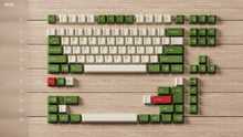 Load image into Gallery viewer, Render of DCS Cream Cheese R3 Base DS Caps Lock Kit - cream and yellow keycaps with red and green accents