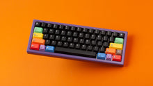 Load image into Gallery viewer, Keycapsule Prism dark on a purple keyboard angled
