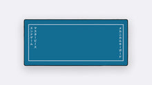 Load image into Gallery viewer, Masterpiece R2 deskpad, Endgame design - teal blue with white border frame and Japanese text