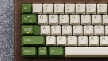 Load image into Gallery viewer, Render of DCS Cream Cheese R3 keycaps on green keyboard, overhead angled view