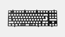 Load image into Gallery viewer, Render of carbon fiber keyboard plate with universal multi-layout switch cutouts