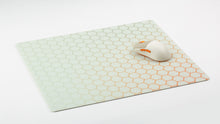 Load image into Gallery viewer, NovelKeys Glasspad with orange honeycomb texture and the NK-M1 mouse resting on top