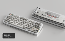 Load image into Gallery viewer, Render of Matrix Carnival keyboard in Anodized Silver, showing front with keycaps and back with decorative weight