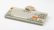 Load image into Gallery viewer, NK-M1 beige mouse beside a beige Classic TKL keyboard with orange Esc and Enter keys