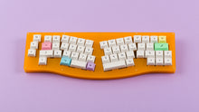 Load image into Gallery viewer, DSA Milkshake on an orange keyboard centered