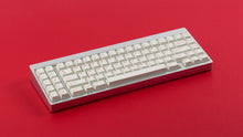 Load image into Gallery viewer, Cherry Ember on a silver keyboard angled
