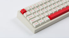 Load image into Gallery viewer, Cherry Ember on a beige keyboard zoomed in left