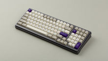 Load image into Gallery viewer, Cherry Spellbook on a gray keyboard angled